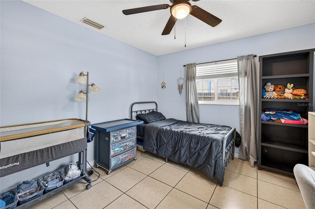 532 Center Road Venice, FL 34285 - Photo 22 of 68 a bedroom with a bed and a chandelier