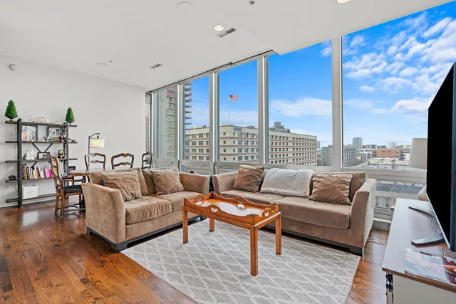 a living room with furniture city view and large windows