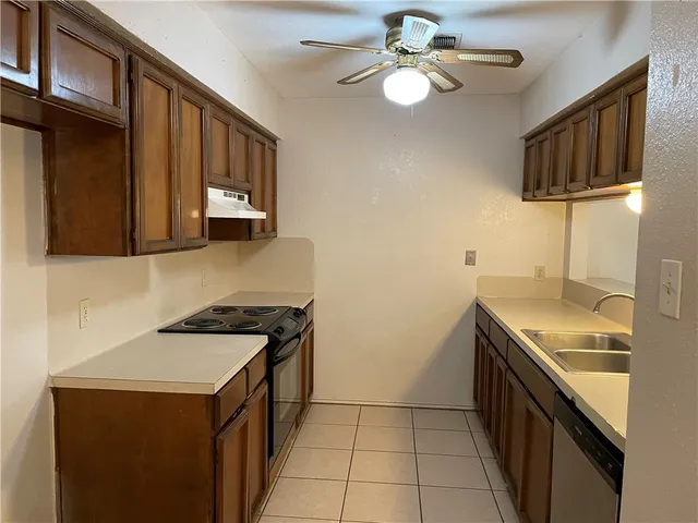 a kitchen with stainless steel appliances a stove a sink and a microwave
