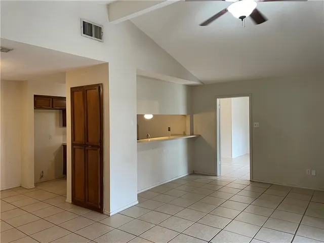 a view of a kitchen with refrigerator and cabinet