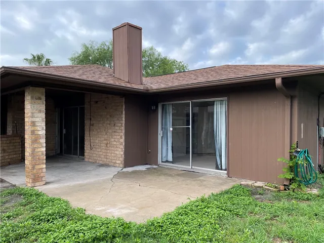 a view of a house with a garage and plants