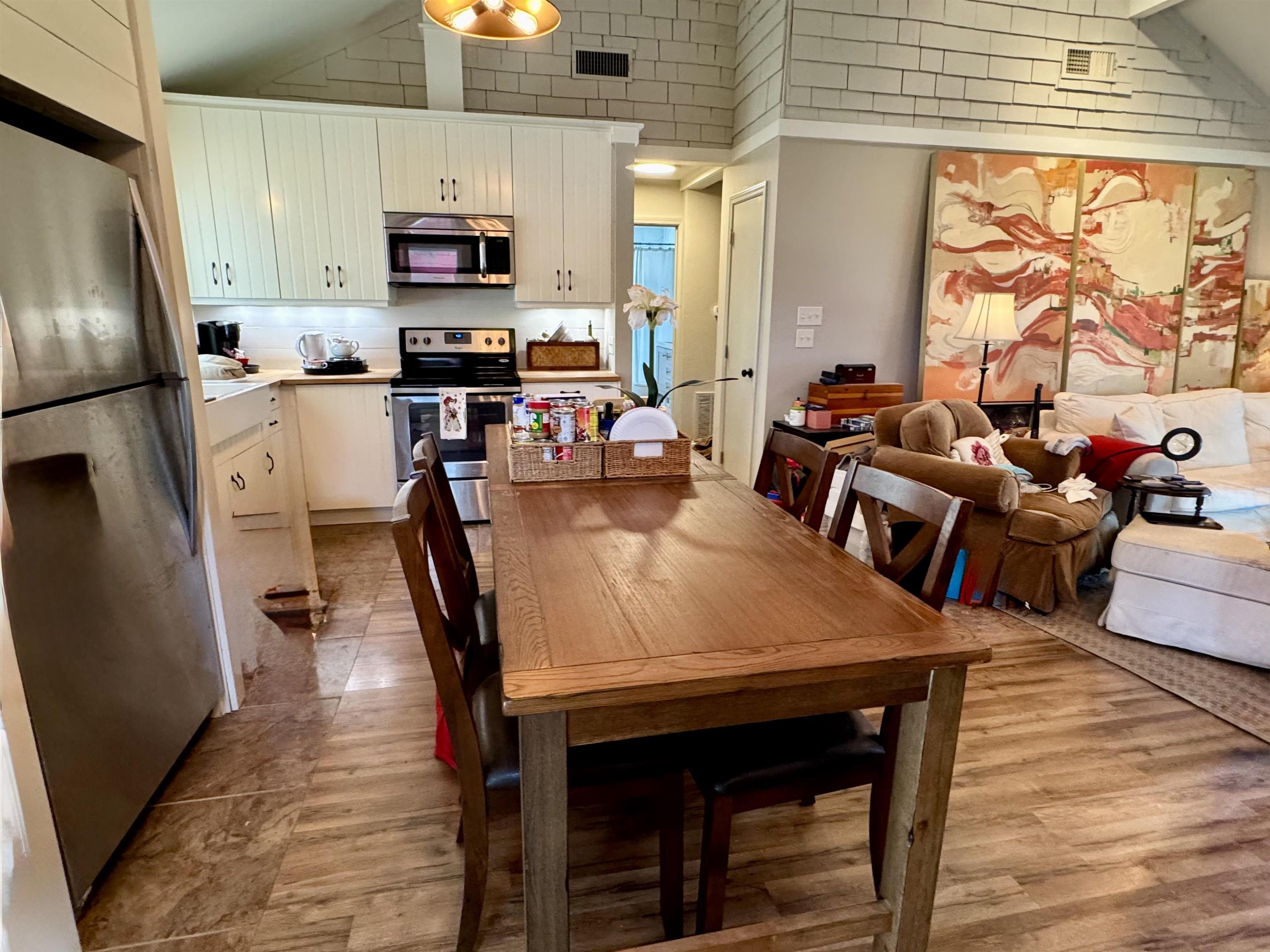402 Laurel Lane Burnet, TX 78611 - Photo 5 of 30 a view of kitchen with stainless steel appliances granite countertop wooden floor dining table and chairs