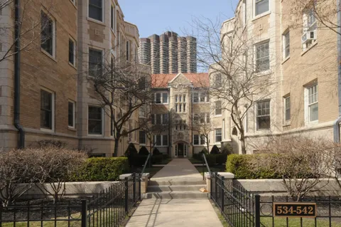 a view of a brick building next to a yard