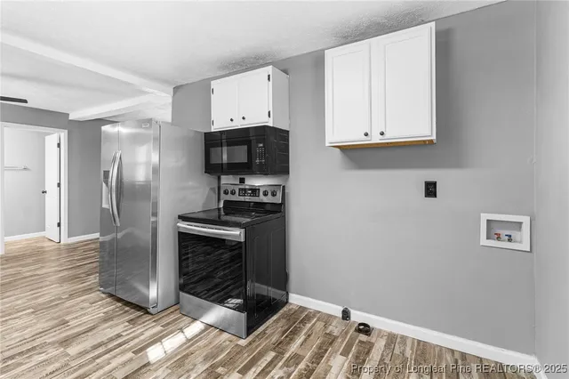 a kitchen with granite countertop a stove and a refrigerator
