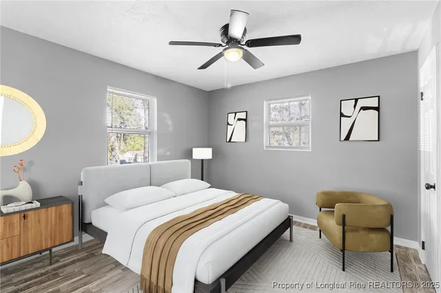 a bedroom with a bed a couch and a window