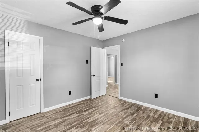 a view of a room with a ceiling fan