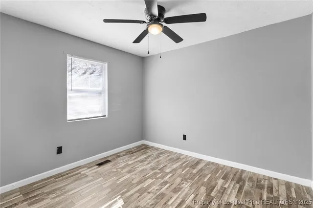 a view of empty room with ceiling fan