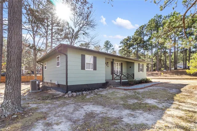 a view of a house with a yard covered in snow