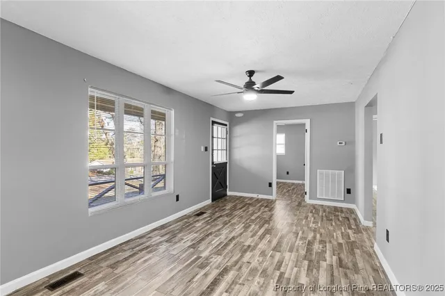 wooden floor in an empty room with a window