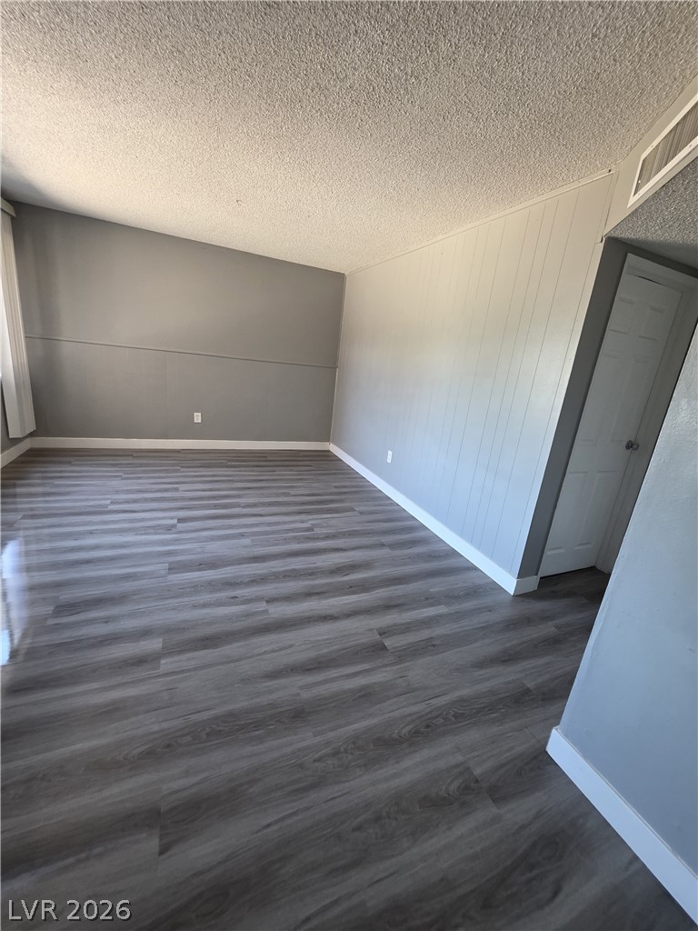 1089 East Desert Inn Road, Unit 3 Las Vegas, NV 89109 - Photo 14 of 15 Newly installed wood-look flooring enhances this versatile, ready-to-personalize interior space.