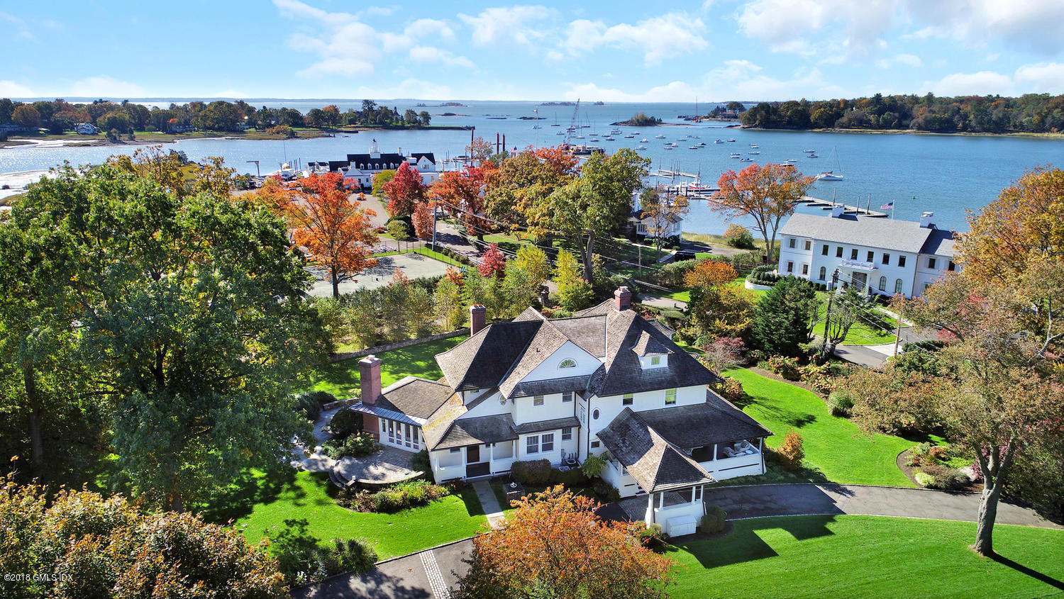 an aerial view of a house with a garden and lake view