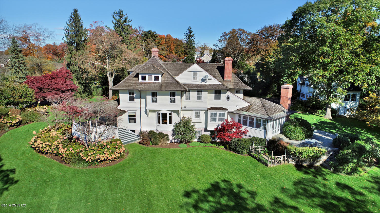 96 Club Road Riverside, CT 06878 - Photo 2 of 33 a front view of a house with a garden and plants