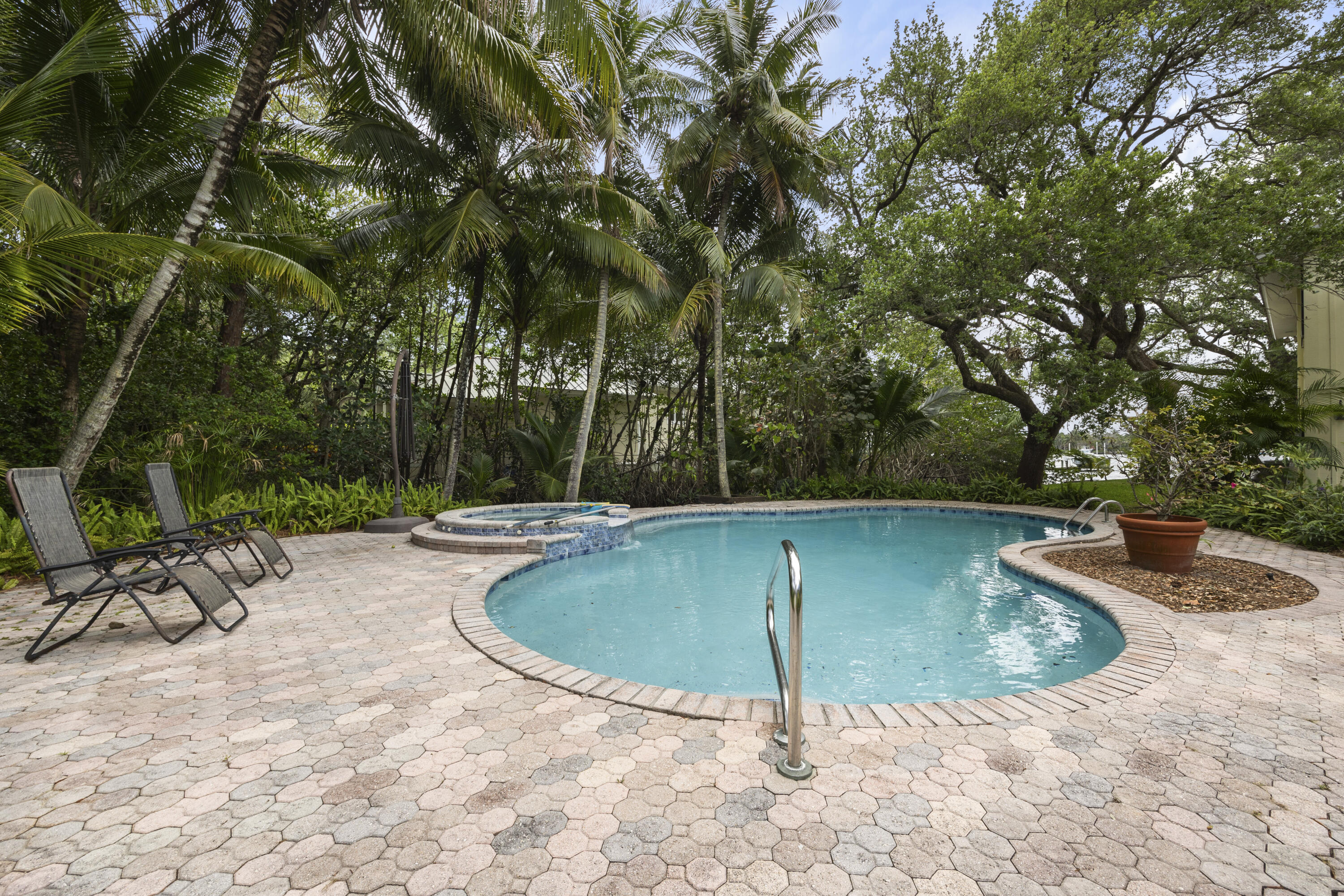 5524 Pennock Point Road Jupiter, FL 33458 - Photo 40 of 78 a view of a swimming pool with a patio