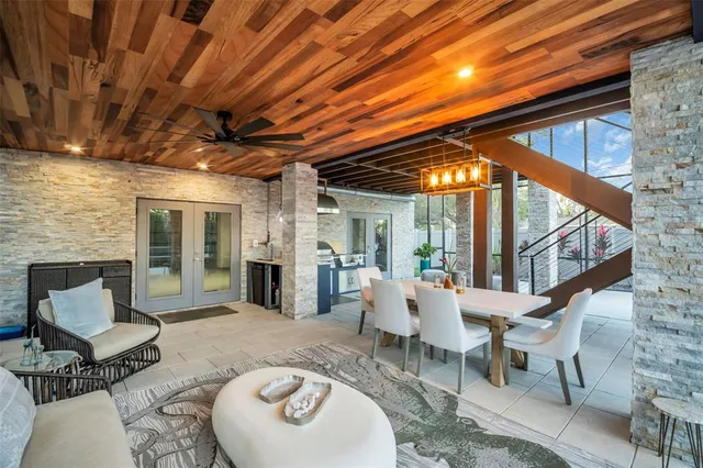 a living room with furniture and a floor to ceiling window