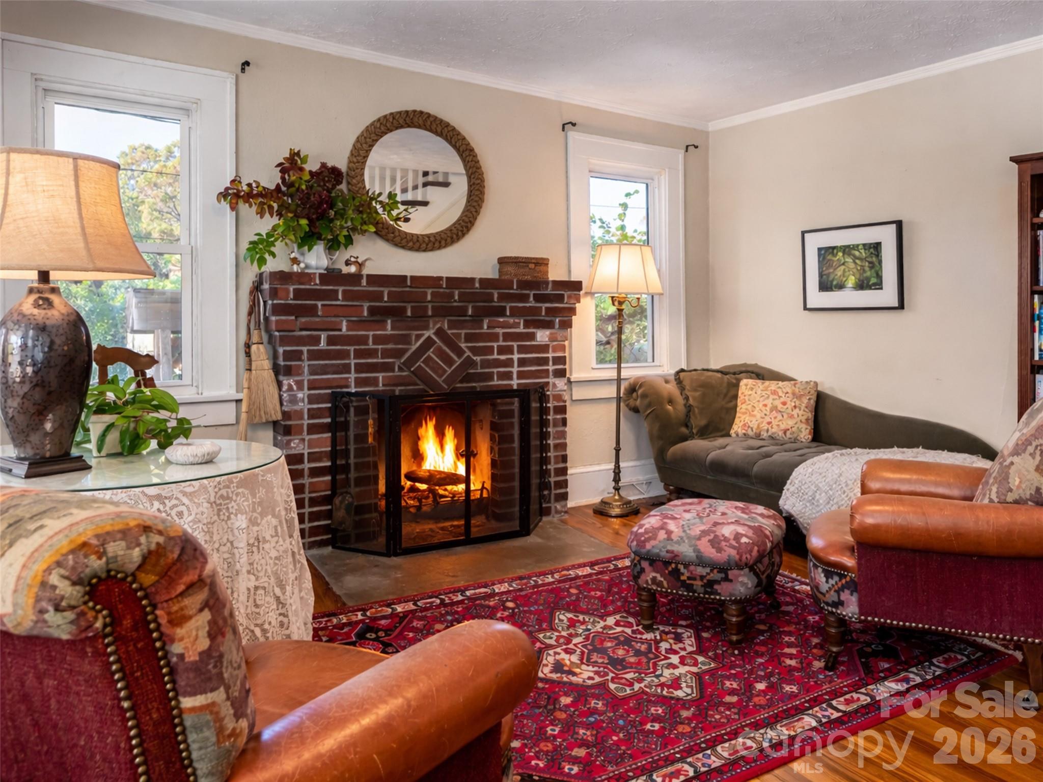 352 Justice Ridge Road Candler, NC 28715 - Photo 12 of 48 a living room with furniture a clock and a fireplace