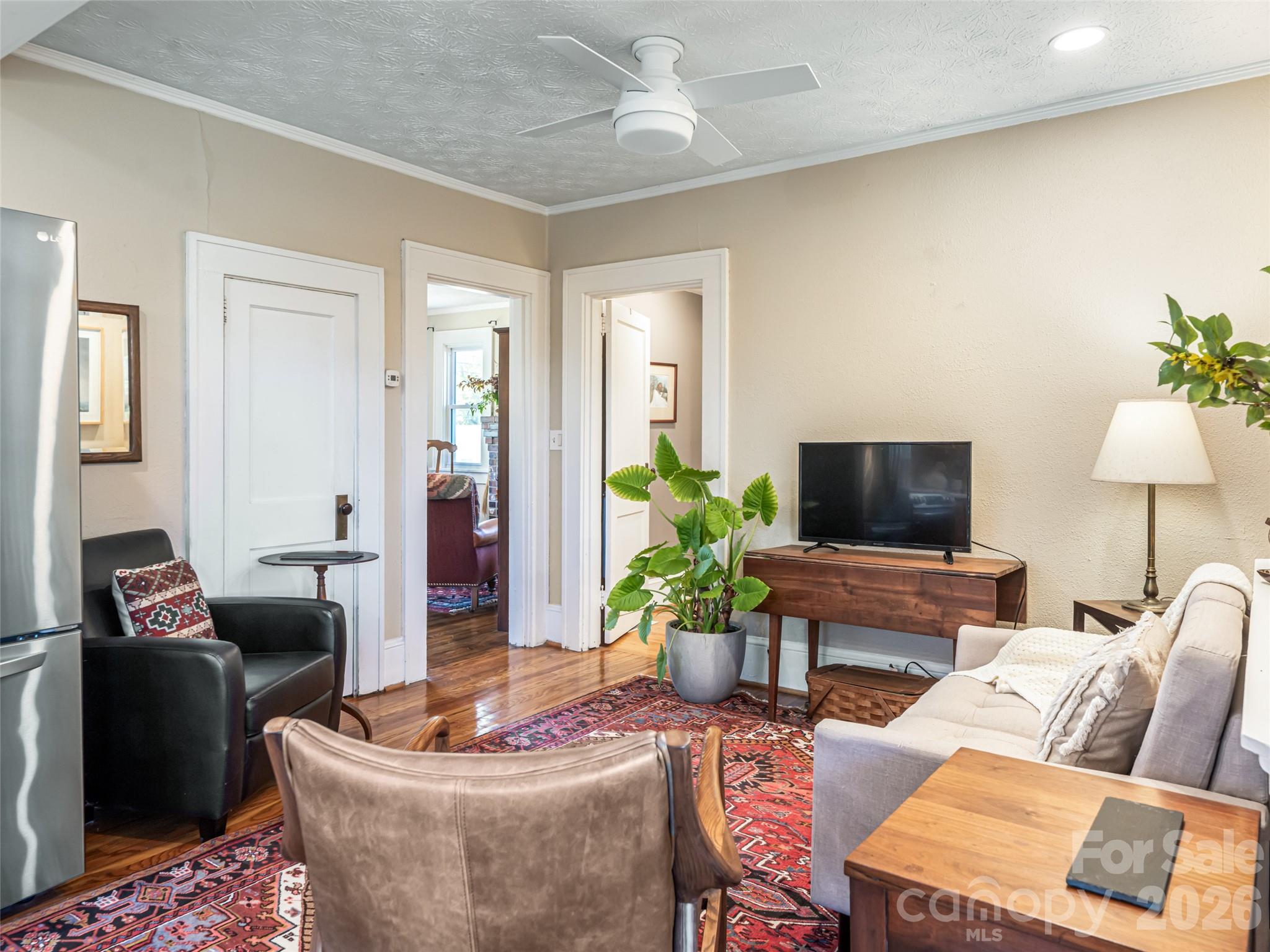 352 Justice Ridge Road Candler, NC 28715 - Photo 16 of 48 a living room with furniture and a flat screen tv