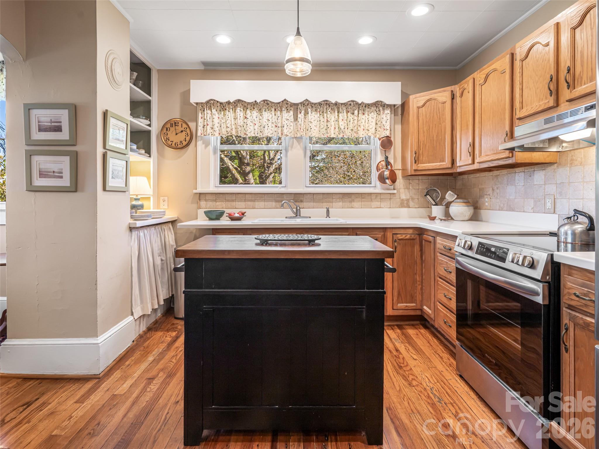 352 Justice Ridge Road Candler, NC 28715 - Photo 19 of 48 a kitchen with a stove and a sink
