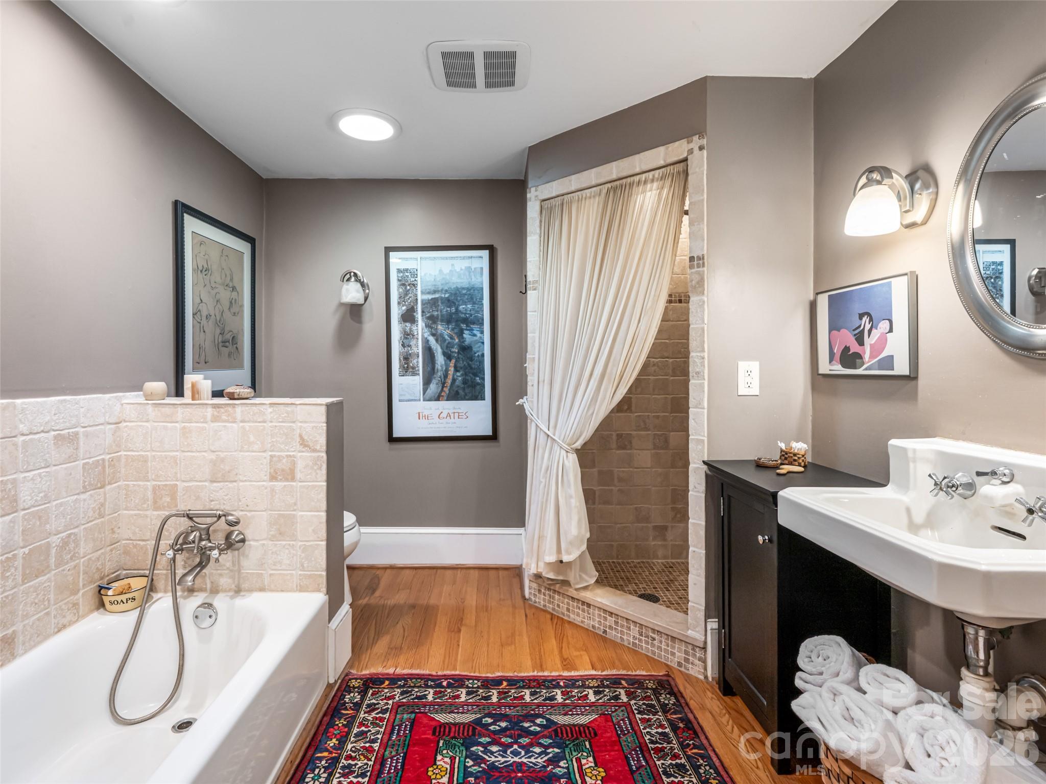 352 Justice Ridge Road Candler, NC 28715 - Photo 23 of 48 a bathroom with a tub sink and mirror