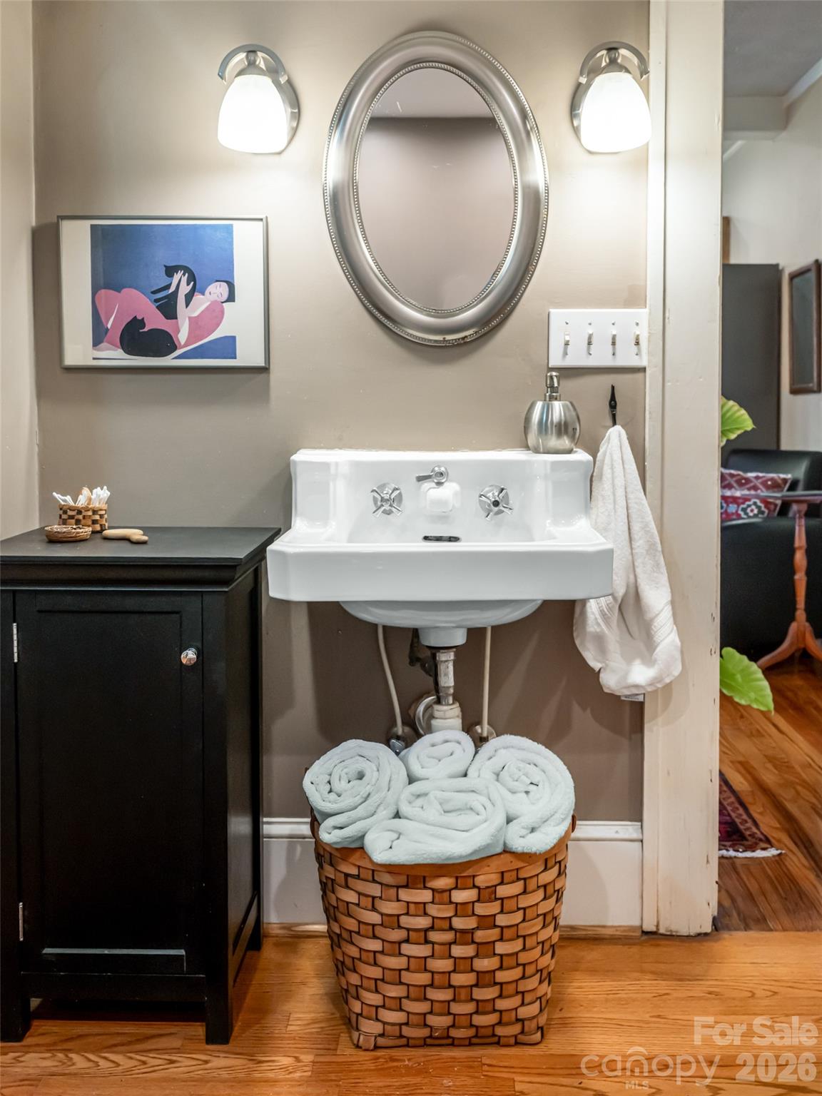 352 Justice Ridge Road Candler, NC 28715 - Photo 26 of 48 a bathroom with a sink a mirror and a view of living room