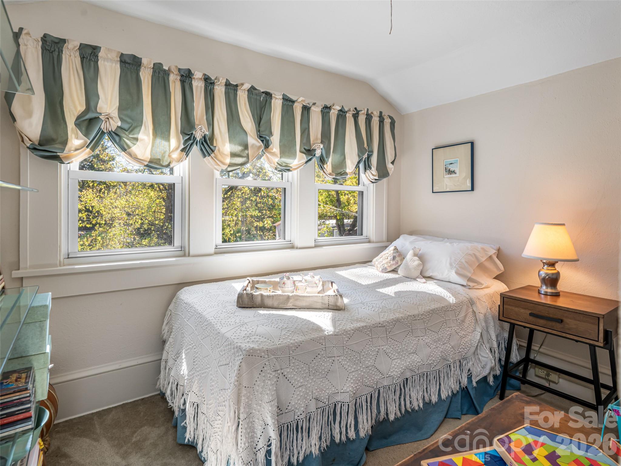 352 Justice Ridge Road Candler, NC 28715 - Photo 29 of 48 a bedroom with a bed and a window