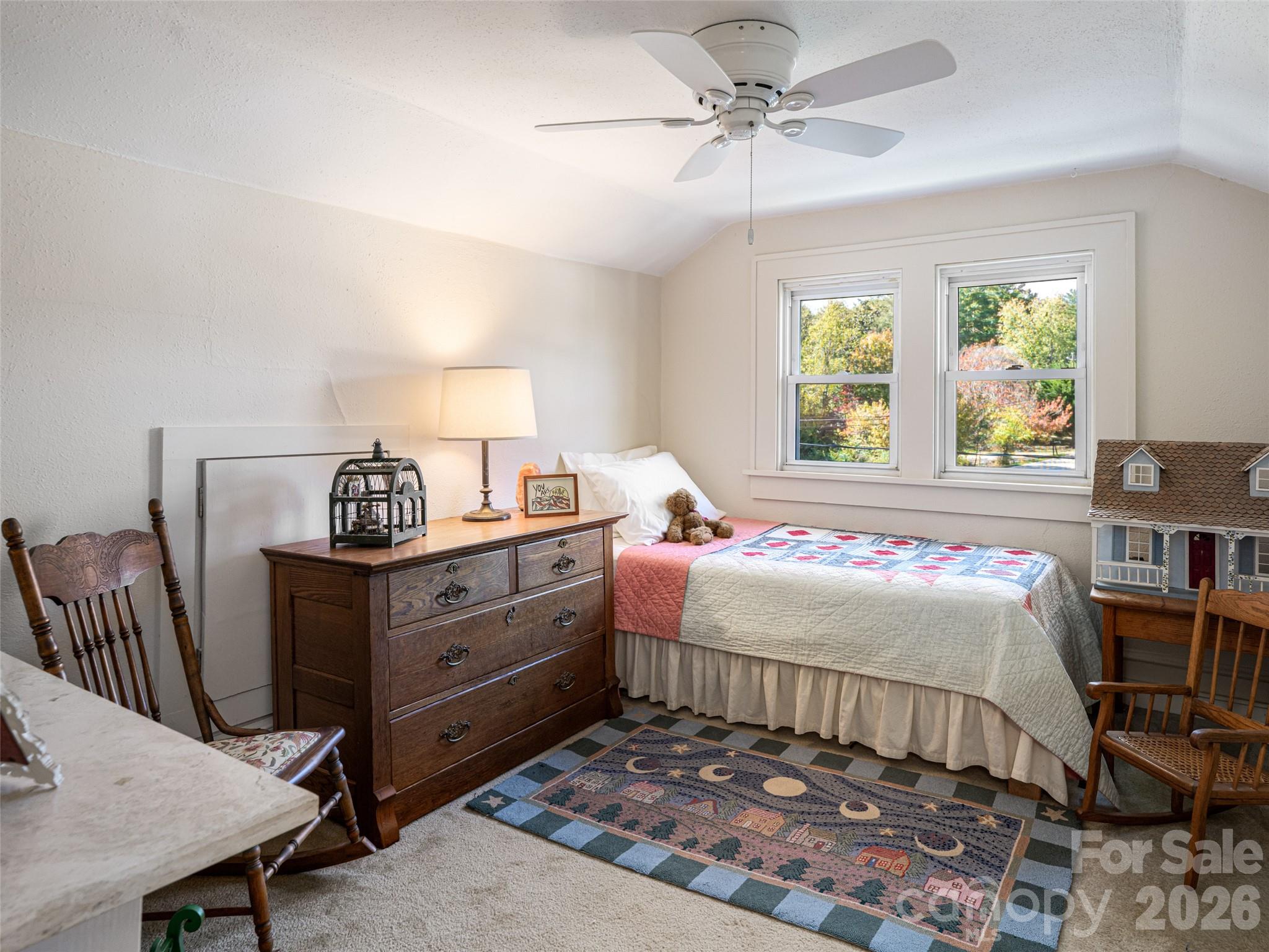352 Justice Ridge Road Candler, NC 28715 - Photo 30 of 48 a bedroom with a bed and a table in it