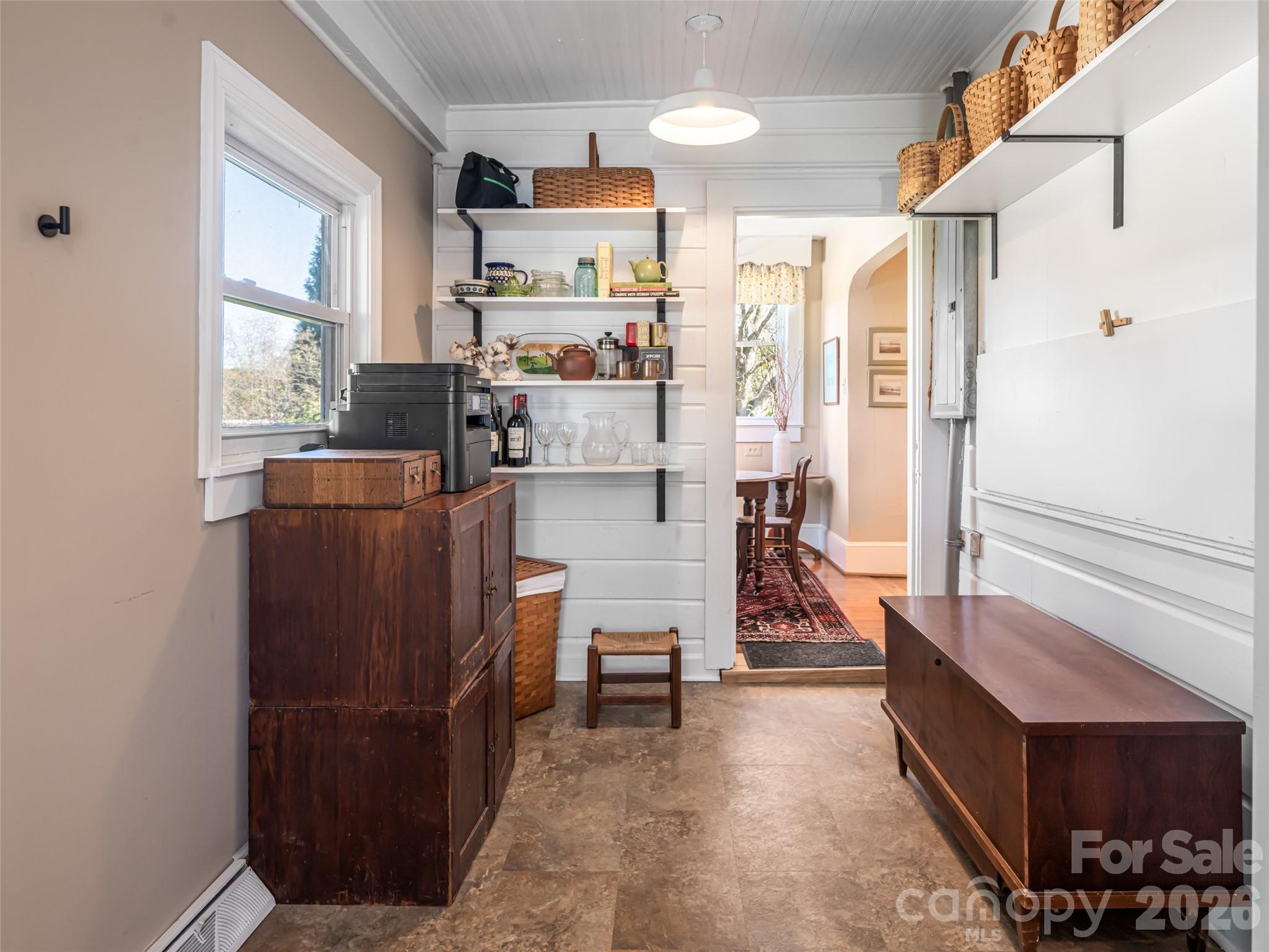 352 Justice Ridge Road Candler, NC 28715 - Photo 32 of 48 a living room with furniture and a dining table next to a window
