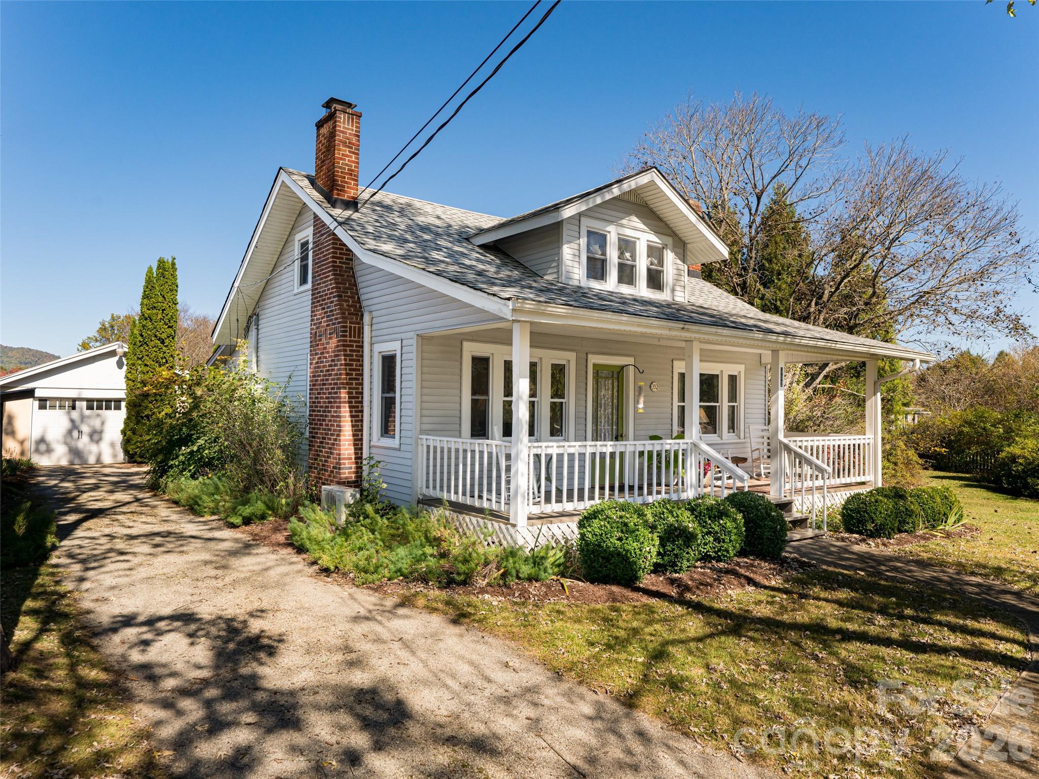 352 Justice Ridge Road Candler, NC 28715 - Photo 4 of 48 a front view of a house with garden