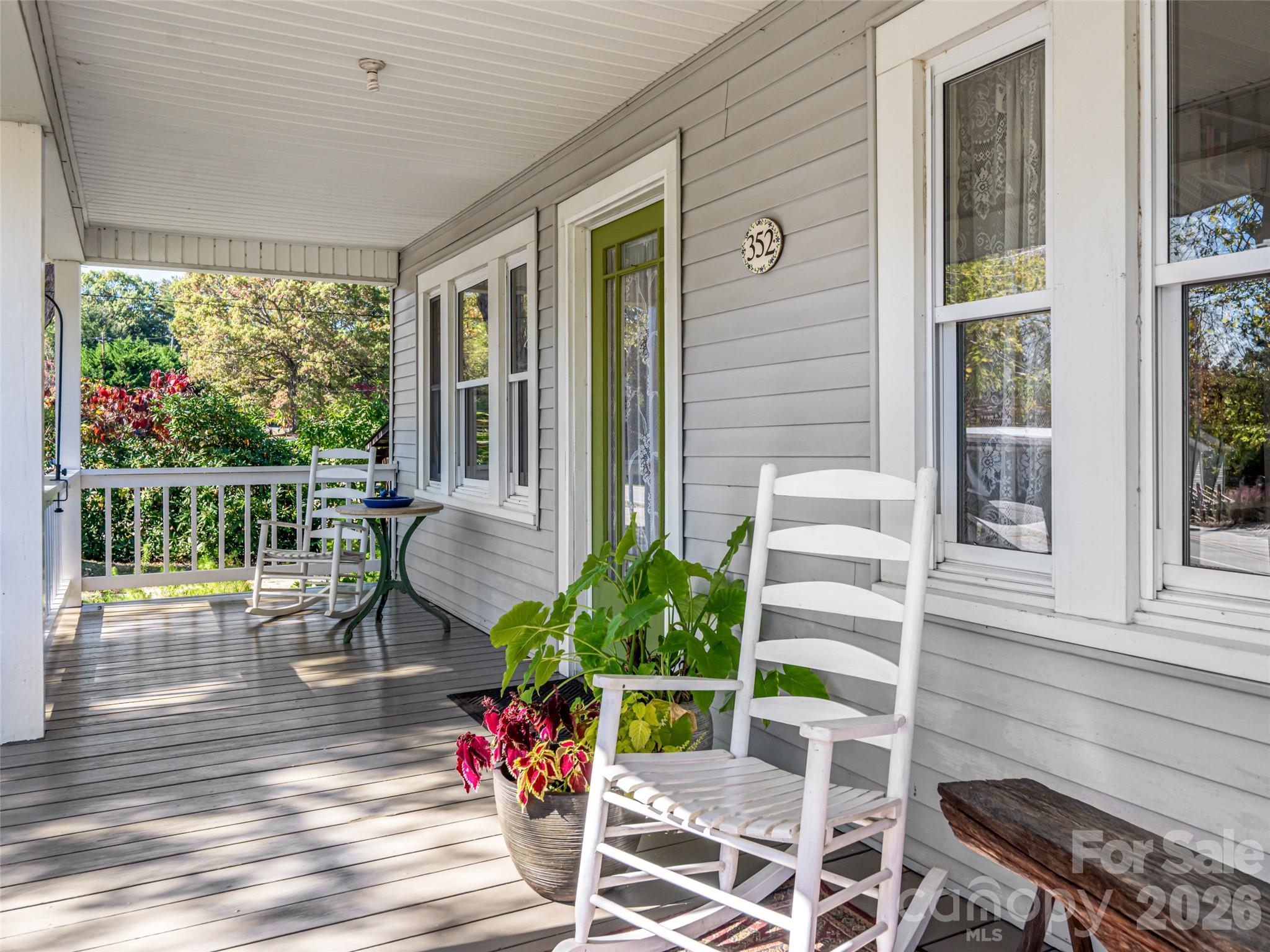352 Justice Ridge Road Candler, NC 28715 - Photo 8 of 48 a view of a porch with chairs and potted plants