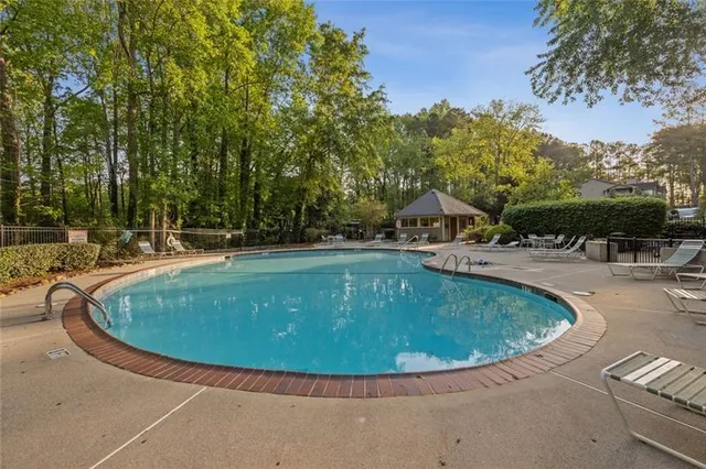 a view of a swimming pool with a yard