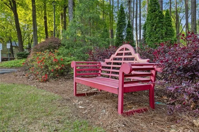 a wooden bench sitting in the middle of a forest