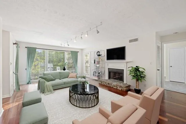 a living room with furniture fireplace and a large window