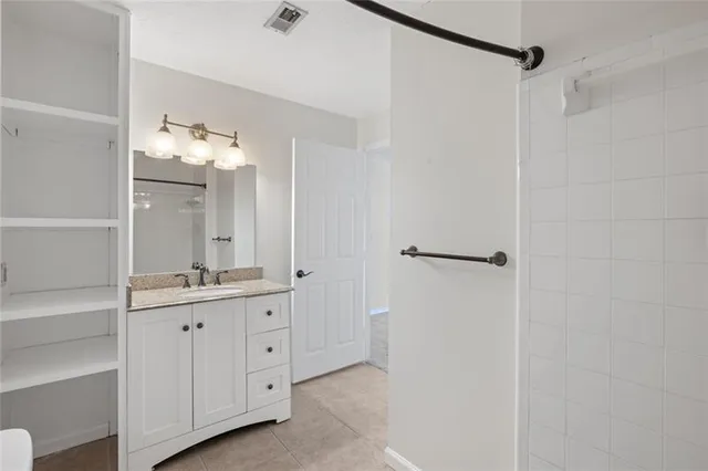 a bathroom with a double vanity sink and mirror