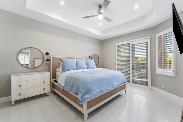 a bathroom with a granite countertop toilet sink and mirror