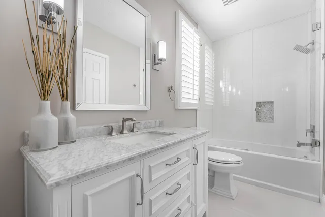 a view of a house with swimming pool and sitting area