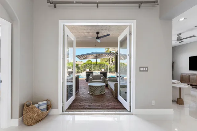 a view of a patio with table and chairs potted plants and a table