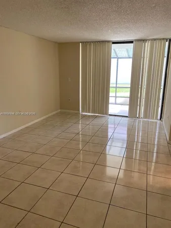 a view of an empty room and a window
