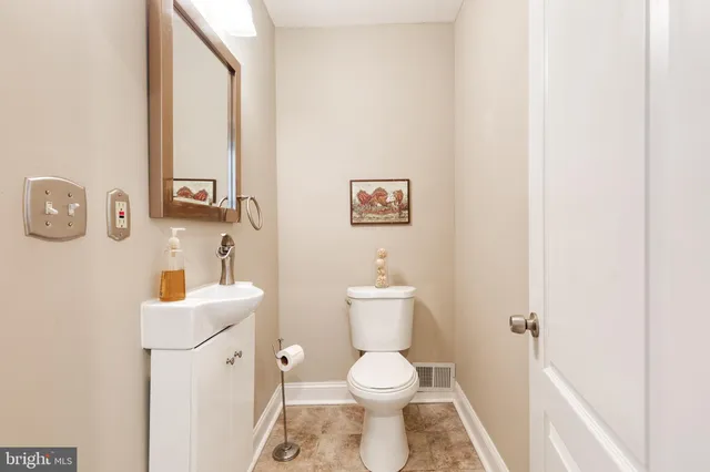 a white toilet sitting next to a bathroom sink