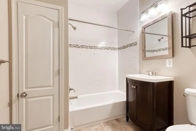 a bathroom with a sink mirror toilet and bathtub