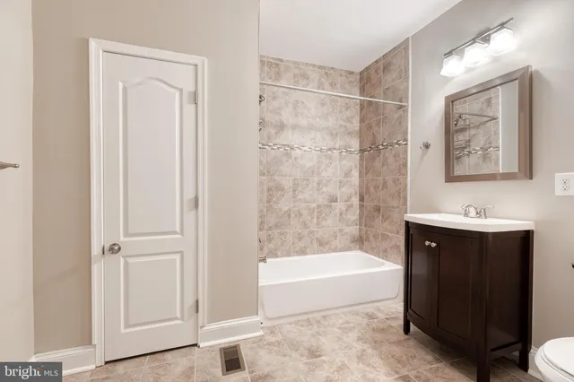 a bathroom with a bathtub a shower a sink and a window