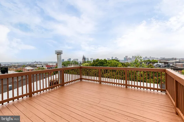 a view of roof deck with two chairs and wooden floor