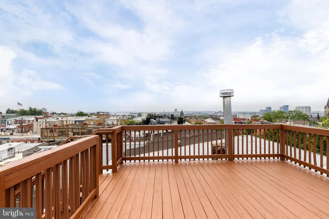 a balcony with chairs and a table