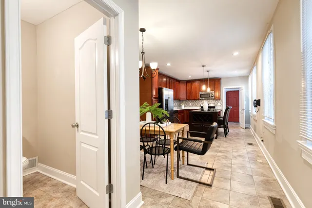a living room with furniture a dining table and chairs