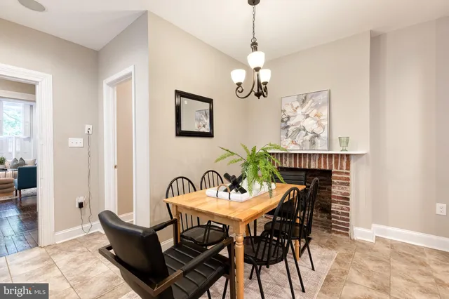 a view of a dining room with furniture wooden floor and a chandelier