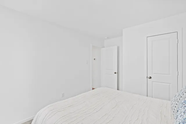 a view of a bedroom with a wooden bed