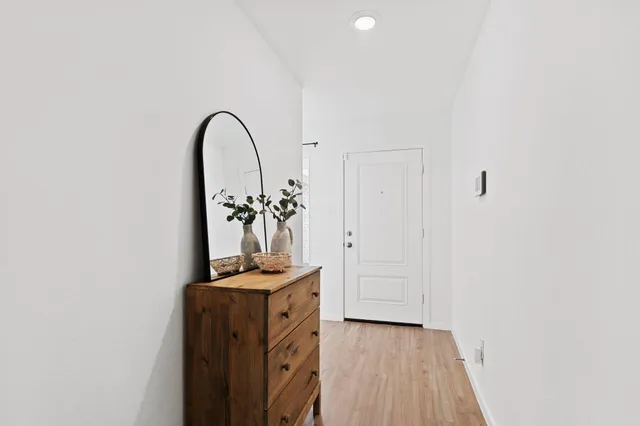 a view of a room with wooden floor