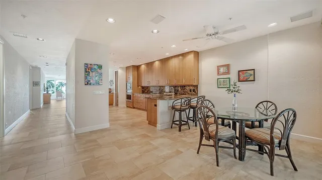 a large kitchen with stainless steel appliances wooden cabinets and a stove top oven