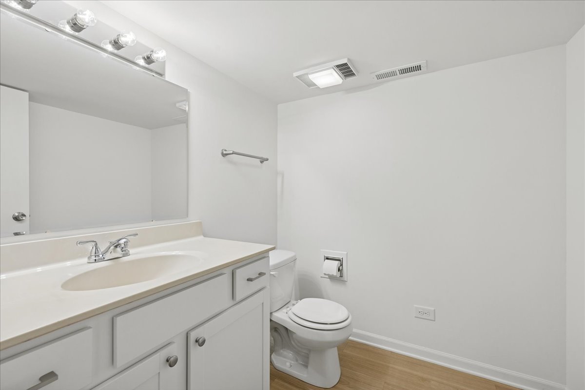 53 North McLean Boulevard Elgin, IL 60123 - Photo 11 of 16 a bathroom with a sink a toilet and mirror