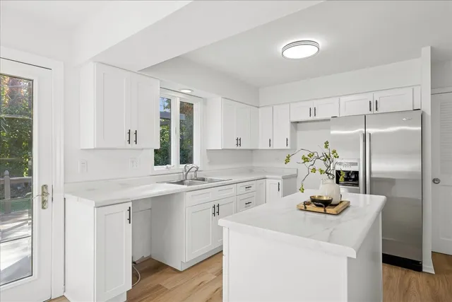 a kitchen with a sink appliances and cabinets