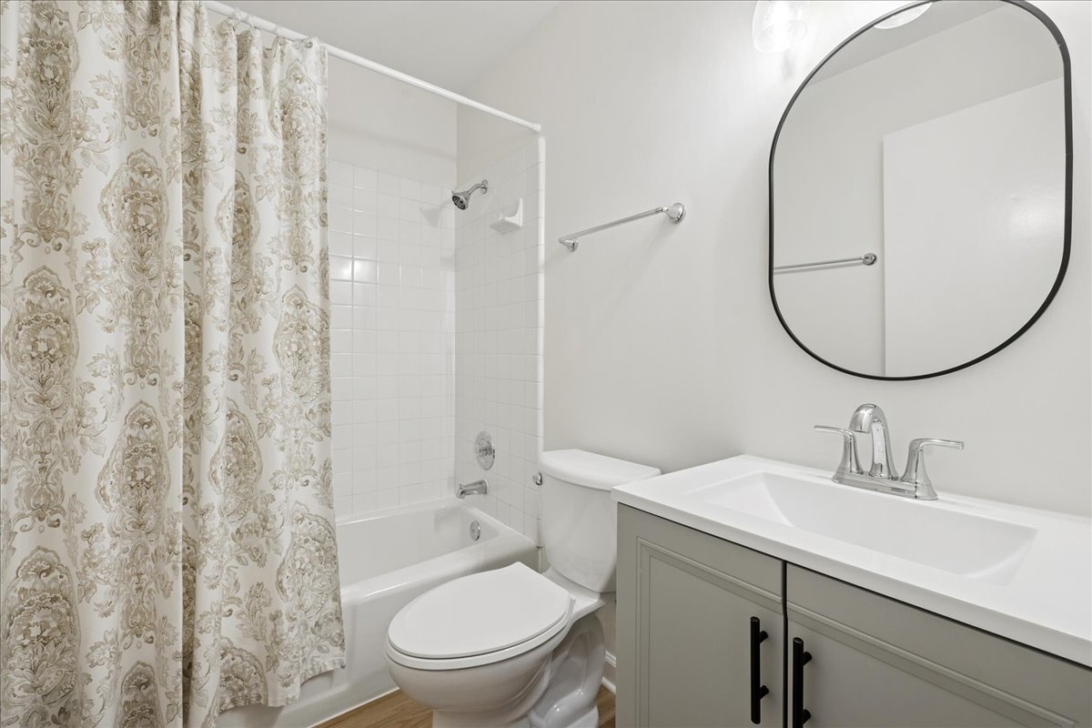 53 North McLean Boulevard Elgin, IL 60123 - Photo 6 of 16 a bathroom with a sink toilet and a mirror