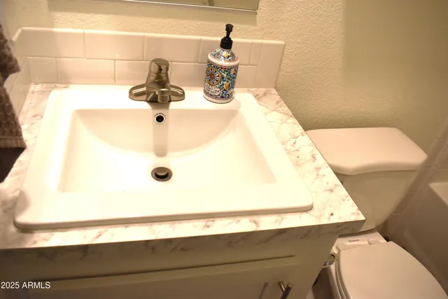 a large bed sitting in a bedroom next to a window